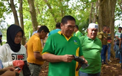<p><strong>SOIL BAGGING.</strong> Abdulraof Macacua (center), Ministry of Environment, Natural Resources and Energy – Bangsamoro Autonomous Region in Muslim Mindanao (MENRE-BARMM) chief, leads his staff in holding a soil-bagging activity to prepare young trees for future tree-planting activities. The activity, held on Thursday (June 13) at the regional tree seedlings nursery in Barangay Dimapatoy, Datu Odin Sinsuat, Maguindanao, coincides with the celebration of the Environment Month this June. <em><strong>(Photo courtesy of MENRE-BARMM)</strong></em></p>