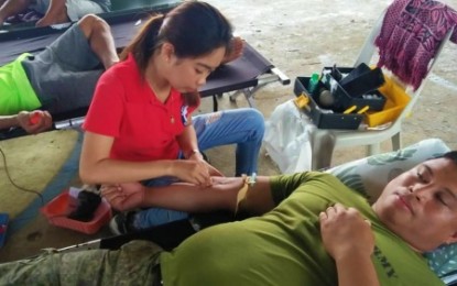 <p><strong>PRECIOUS BLOOD.</strong> A nurse extracts blood from a soldier of the Army’s 33rd Infantry Battalion during a blood-letting program in Barangay Masiag, Bagumbayan, Sultan Kudarat  on Friday (June 14, 2019). The event coincided with the observance of World Blood Donor Day. <em>(Photo courtesy of 33rd IB)</em></p>