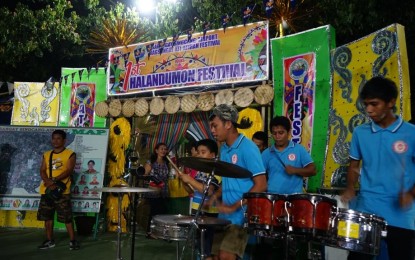 <p><strong>NEW FESTIVAL.</strong> Merry-makers of Barangay Singcang-Airport perform in front of their booth for the 1<sup>st</sup> Halandumon Food and Trade Fair being held behind the Bacolod City Government Center. A related event, the 1<sup>st</sup> Halandumon Festival, a street and arena dance competition featuring the festivals of this city’s barangays, will be held on Sunday (June 16, 2019). <em>(Photo courtesy of Bacolod City PIO)</em></p>
