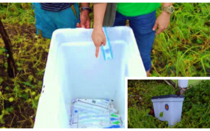 <p><strong>FLOATING BALLOT BOX.</strong> Residents of Datu Salibo, Maguindanao show the election paraphernalia found inside a ballot box recovered from the marshy area at the back of Datu Salibo town hall (inset) by a fisherman on Friday, June 14, 2019. <em><strong>(Photo by Sam Esmael of Datu Salibo, Maguindanao).</strong></em></p>