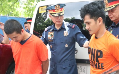 <p><strong>NABBED.</strong> National Capital Region Police Office Chief Maj. Gen. Guillermo Eleazar presents to the media two suspected members of terrorist group Dawlah Islamiyah. The two were arrested last Saturday in Tandang Sora, Quezon City. <em>(Photo by Lloyd Caliwan)</em></p>