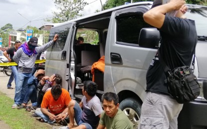 <p><strong>BUSTED.</strong> Police Senior Master Sgt. Ricky Usman Sabturani of the Basilan Police Provincial Office (in orange shirt) hides his face from the camera after he and four others were arrested Friday (June 21, 2019) in a buy-bust operation in San Jose District, Pagadian City. Some PHP3.4 million worth of shabu were seized during the operation. <em>(Photo by Leah D. Agonoy)</em></p>