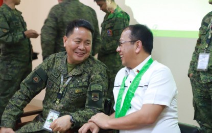 <p><strong>WORK FOR PEACE.</strong> Presidential Peace Adviser Carlito Galvez Jr. (right) and 7th Infantry Division commander, Maj. Gen. Lenard Agustin share a light moment during a meeting in Santa Rosa, Nueva Ecija on June 21, 2019 where they identified areas for collaboration to fast-track the implementation of Whole-of-Nation Approach under Executive Order 70 in Region III (Central Luzon). Galvez assured full support to the Armed Forces of the Philippines to achieve enduring peace and security in the country. <em>(photo courtesy of OPAPP)</em></p>