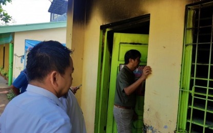 <p><strong>DAMAGE ASSESSMENT.</strong> Mayor Joseph Evangelista of Kidapawan City (right) inspected Tuesday (June 25) the damaged two-classroom school building of the Isidoro Lonzaga Memorial Elementary School in Barangay Magsaysay that was hit by fire on June 21, 2019. The city government pledged to help in the construction of a new school building for the affected students. <em><strong>(Photo courtesy of Kidapawan CIO)</strong></em></p>