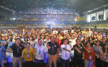 <p><strong>'TSUPER ISKOLAR'. </strong>DOTr Secretary Arthur Tugade and TESDA Director General Isidro Lapena pose with "Tsuper Iskolar" beneficiaries during the launch of the program in Muntinlupa City on Friday (June 28, 2019). About 5,075 “Tsuper Iskolars”, including 25,000 families, are beneficiaries of the program. <em>(Photo courtesy of Department of Transportation) </em></p>
