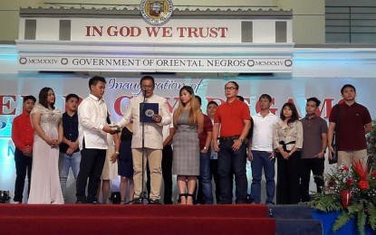 <p><strong>OATH OF OFFICE. </strong>Reelected Negros Oriental Governor Roel Degamo (fifth from left) takes his oath of office in the presence of his wife, Mayor Janice Degamo of Pamplona town (2nd from left) and other family members at the Negros Oriental Convention Center on Sunday (June 30, 2019). In his inaugural address, he cited his administration's almost 100 percent accomplishment of programs and projects in the past three years. <em>(Photo contributed by Neil Rio)</em></p>