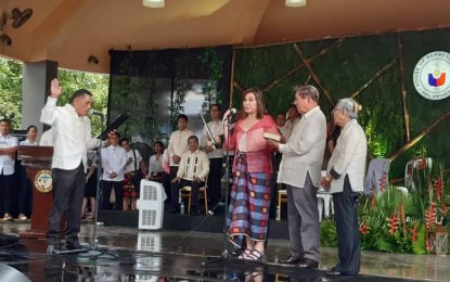 <p><strong>OATHTAKING.</strong> Antique Rep. Loren Legarda takes her oath before Barangay Captain Macario A. Bagac of Barangay Mag-aba, Pandan on Sunday (June 30, 2019). She urged all Antiqueños to have 'malasakit' (concern) for the province.<em> (PNA photo by Annabel J. Petinglay)</em></p>