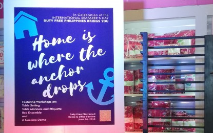 <p><strong>DUTY FREE REWARDS PROGRAM.</strong> Poster of the "Home is Where the Anchor Drops" workshop for Filipino seafarers at the Fiestamall in Parañaque City on Sunday (June 30, 2019). To date, seafarers from 20 DFPC-accredited manning agencies enjoy perks and exclusive discounts through the Seafarer Shopping Privilege Program.<em> (PNA photo by Joyce Rocamora)</em></p>