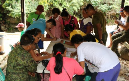 <p><strong>DENOUNCING TERROR.</strong> Some of the 20 mass supporters of the New People's Army (NPA) in Burauen, Leyte, who surrendered to the Philippine Army, sign a document denouncing the terrorist group on June 28, 2019. They also took an oath that they will no longer support the rebels by any means.<em> (Photo courtesy of Philippine Army 78th Infantry Battalion)</em></p>
