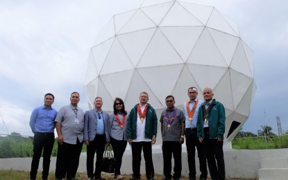<p><strong>LARGEST SATELLITE-TRACKING ANTENNA.</strong> Department of Science and Technology (DOST) officials, led by Secretary Fortunato dela Peña (5th from left), pose for a photo in front of the radome housing the tracking antenna in the Davao Ground Receiving Station of the Philippine Earth Data Resource Observation (PEDRO) Center of the DOST-Advanced Science and Technology Institute. It is designed to communicate with Earth observation satellites, including the Philippines' very own Diwata-1 and Diwata-2 microsatellites, by receiving, processing, and distributing space-borne imagery.<em> (Photo courtesy of DOST)</em></p>