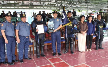 <p><strong>CDM CHAMPIONS</strong>. Pangasinan Police Provincial Office (PPPO) acting director Col. Redrico Maranan and the team leader of the PPPO's Civil Disturbance Management (CDM) Team receive the award as overall champion of the Police Regional Office 1 CDM competition. The competition is aimed at testing the operational readiness, competency, and capability of the team in handling civil disturbances and massive protests. <em>(Photo courtesy of the Police Regional Office 1)</em></p>