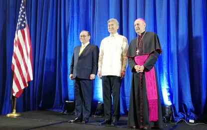 <p>(From left) Foreign Affairs Secretary Teodoro Locsin Jr., US Ambassador Sung Kim, and the Papal Nuncio Archbishop Gabriele Giordano Caccia during the 243rd anniversary of US Independence in Makati City. <em>(PNA photo by Joyce Ann L. Rocamora)</em></p>