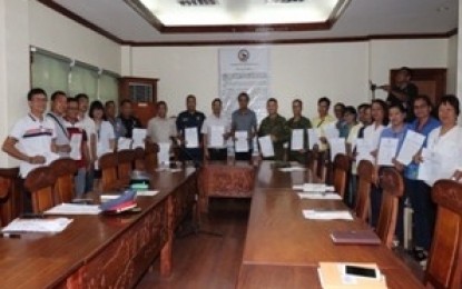 <p><strong>RESOLUTION VS. CPP-NPA.</strong> Members of the Aurora Peace and Order Council headed by Governor Gerardo Noveras (center), hold the approved resolution which condemns the actions and activities of the Communist Party of the Philippines-New People’s Army (CPP-NPA), including its front group and affiliates, during the meeting held at the provincial capitol in Baler, Aurora on Thursday (July 4, 2019). The council said the activities of the communist rebels hamper the peace and development of the province.<em> (Photo by Jason de Asis)</em></p>
