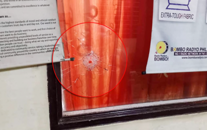 <p><strong>RADIO STATION ATTACK.</strong> A bullet tears through the recording room of Bombo Radyo General Santos City after unidentified gunmen sprayed bullets on the radio station Wednesday evening. <em>(Photo from Bombo Radyo Gensan Facebook Page)</em></p>