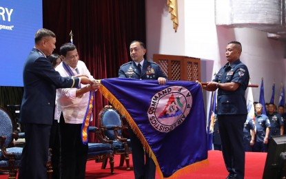 <p><strong>PAF'S 72ND ANNIVERSARY. </strong>President Rodrigo Roa Duterte attaches the streamer on the banner of one of the award-winning Philippine Air Force (PAF) units during the 72nd PAF Anniversary at the Col. Jesus Villamor Air Base in Pasay City on Tuesday (July 2, 2019). Assisting the President is PAF Commander Lieutenant General Rozzano Briguez. <em>(Valerie Escalera/Presidential Photo)</em></p>