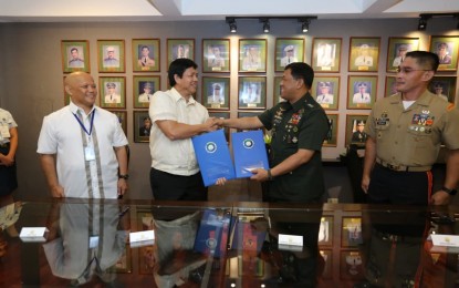<p><strong>JOINING HANDS. </strong>DSWD Secretary Rolando Bautista (left) and AFP Chief-of-Staff Gen. Benjamin Madrigal shake hands after the signing of a memorandum of understanding (MOU) seeking to enhance the cooperation of the two agencies in Camp Aguinaldo on Thursday (July 4, 2019). The MOU includes the formulation of peace-building programs and ending the threat posed by the conflict with the communists. <em>(Photo courtesy: AFP Public Affairs Office)</em></p>