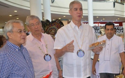 <p><strong>BUSINESS WEEK.</strong>  Negros Occidental Governor Eugenio Jose Lacson (second from right), along with Metro Bacolod Chamber of Commerce and Industry chief executive officer Frank Carbon (left) and president Roberto Montelibano (second from left), tours the booths of participating enterprises during the opening of the 11th Negros Business Week at Robinsons Place Bacolod on Saturday (July 6, 2019). Lacson recognized the business group for furthering the interest of small businesses and entrepreneurs in the province. <em>(Photo courtesy of Richard Malihan/NegOcc Capitol PIO)</em></p>