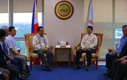 <p><strong>DILG VISIT.</strong> Bangsamoro Autonomous Region in Muslim Mindanao (BARMM) Chief Minister Murad Ebrahim (left) and Department of the Interior and Local Government (DILG) Secretary Eduardo Año during the visit of BARMM officials to the DILG central office on Monday (July 8, 2019). In the same meeting, Año ordered the turnover of Cotabato City and the 63 villages in North Cotabato province under the BARMM jurisdiction after the areas voted for inclusion to the expanded BARMM territory during plebiscite held on January 21 and February 6 this year. <em>(Photo from BPI-BARMM)</em></p>