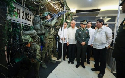 <p><strong>STRONGER FORCE</strong>. President Rodrigo Roa Duterte inspects the equipment of soldiers on the sidelines of the 122nd Founding Anniversary of the Philippine Army at Fort Bonifacio in Taguig City last March 21, 2019. Duterte urged Congress to pass bills that will provide the Armed Forces of the Philippines (AFP) and the Philippine National Police (PNP) with more assets and equipment before the end of his term in 2022. <em>(Presidential Photo)</em></p>