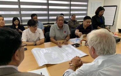 <p><strong>VISAYAS PROJECTS.</strong> Presidential Assistant for the Visayas, Sec. Michael Lloyd Dino (in white shirt), sits with Transportation Secretary Arthur Tugade (center) and Usec. Mark Richmond de Leon (right) during a recent coordination meeting with consultants in Cebu for the Integrated Intermodal Transport System. Dino said the "Build, Build, Build" program of President Rodrigo Duterte during the first three years of his term has spurred the economy of the Visayas region.<em> (Photo courtesy of OPAV)</em></p>