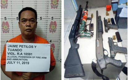 <p><strong>LOOSE FIREARMS IN GENTRI.</strong> Suspect Jaime Petilos and the seized assorted firearms during a simultaneous anti-criminality raid in General Trias City, Cavite on July 11, 2019. <em>(PNA photo by Dennis Abrina) </em></p>