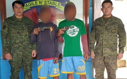 <p><strong>MORE SURRENDERERS.</strong> Another two New People's Army (NPA) rebels surrender Thursday, July 11, in Siay, Zamboanga Sibugay, saying the communist rebel movement had deceived them. The two pose for posterity picture together with Lt. Col. Don Templonuevo, Army's 44th Infantry Battalion commander (left) and another officer of the same battalion after their surrender. <em>(Photo courtesy of Army's 44th Infantry Battalion)</em></p>