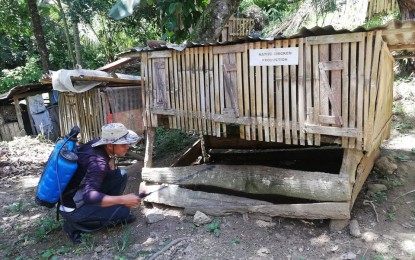 <p>YOUNG ORGANIC  FARMER. Janel Juaton disinfects the cage of his native chickens using an organic concoction, on Saturday (July 13, 2019). He is set to receive an award as the most outstanding young organic farmer in Davao region this August.<em> (Photo by Che Palicte) </em></p>