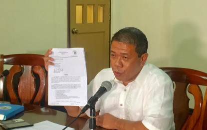 <p><strong>SUSPENSION ORDER.</strong> Jenielito Atillo, spokesperson of Department of Education-Region 11 shows the letter of suspension for the 55 Salugpongan tribal schools in Davao Region during a media briefing on Monday (July 15). <em>(Photo by Che Palicte)  </em></p>