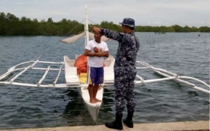 <p><strong>PRECAUTION.</strong> A member of the Philippine Coast Guard-Central Visayas advises a motorboat operator about the unfavorable weather condition brought by tropical depression Falcon on Tuesday (July 16, 2019). "Falcon" is now moving westward over the Philippine area of responsibility, prompting the cancellation of more than 20 trips of fast crafts and smaller sea-going vessels bound for different areas in the Visayas and Bicol regions. <em>(Photo courtesy of Lt. Junior Grade Michael Encina)</em></p>