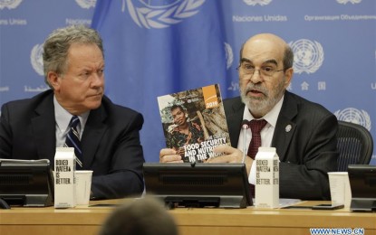 <p><strong>WORLD HUNGER.</strong> Jose Graziano da Silva (right), Director-General of the United Nations Food and Agriculture Organization (FAO), holds a copy of the newly launched report "The State of Food Security and Nutrition in the World 2019", at the UN headquarters in New York Monday (July 15, 2019). World hunger is on the rise in absolute number and more than 820 million people were hungry in 2018, the UN report said Monday. <em>(Photo by Xinhua/Li Muzi)</em></p>