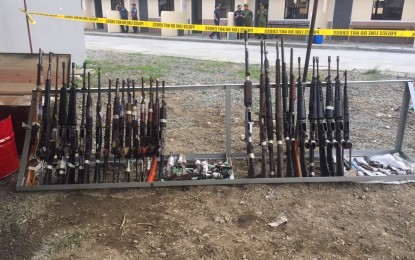 <p><strong>DEMILITARIZED.</strong> Firearms of various caliber are displayed before being demilitarized in Tagum City Tuesday. The firearms were turned in by former New Peoples Army members who have already returned to the folds of the law. <em>(Photo by Che Palicte)</em></p>