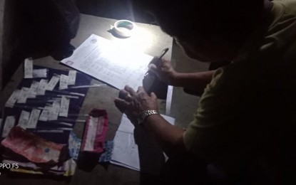 <p><strong>INVENTORY.</strong> A police operative conducts an inventory on the P70,000 worth of suspected shabu seized from a martial arts instructor during a buy-bust operation in Dumaguete City on Wednesday night (July 17, 2019). The suspect refused to disclose the group of martial arts instructors, which he leads.<em> (Photo by Juancho Gallarde)</em></p>