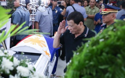 <p><strong>LAST RESPECTS</strong>. President Rodrigo Roa Duterte pays his last respects to one of the slain police officers as he visits the wake at Camp Lt. Col. Francisco C. Fernandez Jr. in Sibulan, Negros Oriental Saturday (July 20, 2019). During his visit, the President honored the four police officers who were killed in an ambush by suspected communist rebels last July 18. <em>(Albert Alcain/Presidential Photo)</em></p>