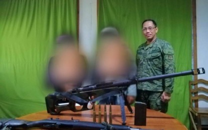 <p><strong>BIFF SURRENDER.</strong> The two Bangsamoro Islamic Freedom Fighters (blurred faces) and their firearms following their surrender to the Army’s 7th Infantry Battalion in Pikit, North Cotabato on Monday (July 22, 2019). At their side is a senior officer of the Army’s 7th IB. <em>(Photo courtesy of 6ID)</em></p>