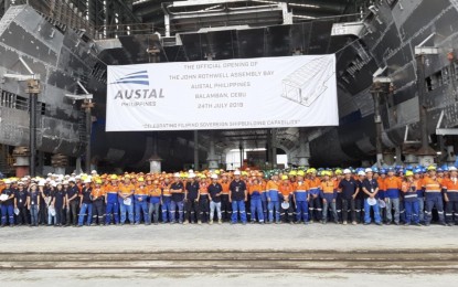 <p><strong>FILIPINO SHIPBUILDERS.</strong> Austal Philippines' Filipino engineers, designers, fabricators, laborers, and accountants pose beneath a catamaran they are constructing for Fjord Line Norway at the John Rothwell Assembly Bay launched at the West Cebu Industrial Park, Arpili, Balamban in Cebu Province on Wednesday (July 24, 2019). Austal Group executives praised the Filipino workers' skills and work ethics and recognized their contribution to the company's continued operation and expansion. <em>(PNA photo by John Rey Saavedra)</em></p>