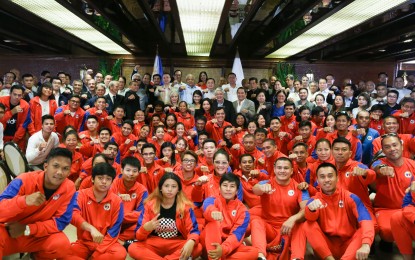 <p><strong>ATHLETES WELFARE.</strong> National athletes do a President Rodrigo Duterte’s signature fist salute with government officials in an event in Malacañang last year. Duterte’s former top aide and now Senator Bong Go called on the Philippine Sports Commission to hasten the release of the athlete’s allowance. <em>(File photo)</em></p>