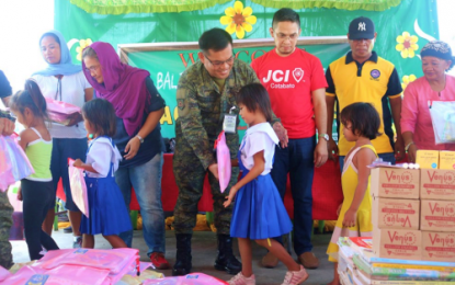 <p><strong>OUTREACH PROGRAM.</strong> Lt. Col. Rogelio Gabi, Army’s 40IB commander, leads partner organizations in distributing school supplies and other treats to pupils of the Midpandacan Elementary School in Barangay Midpandacan, General Salipada K. Salipada, Maguindanao on Friday (July 27, 2019). The activity formed part of the 40IB's efforts to reach out to schools and communities included in their area of responsibility.<em> (Photo courtesy of 40IB, Philippine Army)</em></p>