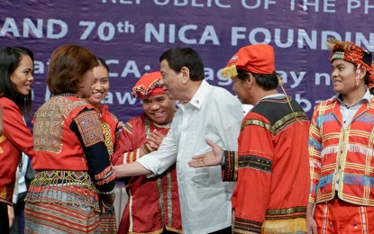 <p>President Rodrigo R. Duterte exchange pleasantries with indigenous peoples' leaders during the 70th founding anniversary celebration of the National Intelligence Coordinating Agency in July 2019. (<em>PPD File photo</em>)</p>