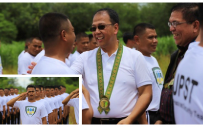 <p><strong>PEACE COMRADES.</strong> Presidential Peace Adviser Carlito Galvez Jr. (center) and Ministry of Environment, Natural, Resources and Energy – Bangsamoro Autonomous Region in Muslim Mindanao Minister Abdulrauf Macacua (in black jacket) huddle with former Moro Islamic Liberation Front (MILF) combatants, who will undergo a month-long Joint Peacekeeping and Security Team (JPST) Basic Military Training starting August 1, 2019 along with military counterparts. A total of 225 MILF trainees (inset) will participate in the exercise in Camp Lucero, the headquarters of the Army’s 602nd Infantry Brigade in Carmen, North Cotabato.<em> (Photo courtesy of OPAPP - Mindanao)</em></p>
