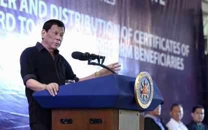 <p>President Rodrigo Duterte delivers his speech after leading the Mindanao-wide turnover and distribution of Certificates of Land Ownership Award (CLOAs) to the Agrarian Reform Beneficiaries (ARBs) at the Davao City Recreation Center on Friday (August 2, 2019). <em>(Contributed photo by Richard Madelo/Presidential photo)</em></p>