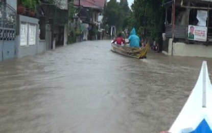 <p><strong>FLOODED VILLAGE</strong>. Residents use a boat as  means of transportation in going out and back to Barangay Almacen in Hermosa, Bataan that remains flooded on Sunday (Aug. 4, 2019). Flash floods hit seven of 11 towns and one city in this province on Saturday, affecting nearly 8,000 families. <em>(Photo by Ernie Esconde)</em></p>