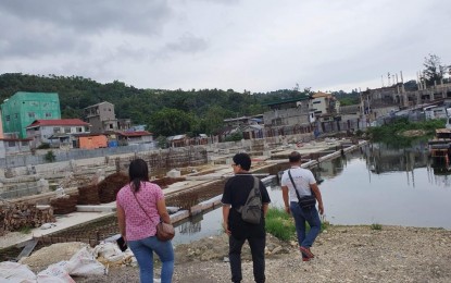 <p><strong>ANTI-DENGUE DRIVE.</strong> Local government workers in Catbalogan City, Samar inspect on August 1, 2019, a construction site at the city's market area identified as a potential breeding ground for mosquitoes. The city government ordered the construction firm to drain the stagnant water.<em> (Photo courtesy of Catbalogan city health office)</em></p>