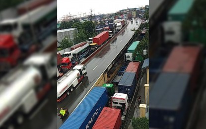 <p><strong>TRUCK BOOKINGS SUSPENDED OVER GRIDLOCK. </strong>Cargo trucks clog the roads surrounding the Port of Manila following the slow processing at the South Harbor brought by inclement weather on August 9, 2019. <em>(Photo courtesy of MDRRMO)</em></p>