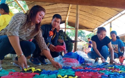 <p><strong>IP ASSISTANCE.</strong> Aileen Usob Hualde (left), executive director of the Women Organization of Rajah Mamalu Descendants (WORMD), prepares the slippers for distribution to IP children during an outreach program in South Upi, Maguindanao on Friday (August 9, 2019). WORMD is a United Nations’ Women partner organization. <em>(Photo courtesy of WORMD)</em></p>