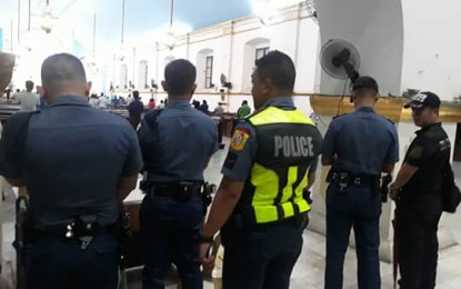 <p><strong>FULL ALERT.</strong> While a mass is heard, men in uniform are deployed in the area to provide security at the St. William Cathedral in Laoag on Sunday (Aug. 11, 2019). <em>(Photo courtesy of the Laoag PNP)</em></p>