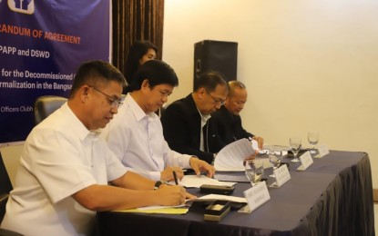 <p><strong>SOCIOECONOMIC AID.</strong> Officials of the Office of the Presidential Adviser on the Peace Process and the Department of Social Welfare and Development signed a memorandum of agreement in Taguig City on Aug. 9, 2019. The agreement, which aims to provide socioeconomic packages to the soon-to-be decommissioned Moro Islamic Liberation Front combatants, was signed by (L-R) DSWD Undersecretary for Disaster Response Management Group Felicisimo C. Budiongan; DSWD Secretary Rolando Joselito D. Bautista; OPAPP Secretary Carlito G. Galvez Jr; OPAPP Undersecretary Arnulfo Pajarillo <em>(Photo courtesy of OPAPP)</em></p>