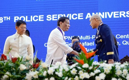 <p><strong>118TH POLICE SERVICE ANNIVERSARY. </strong>President Rodrigo Roa Duterte greets Philippine National Police (PNP) Chief Police General Oscar Albayalde after the latter's welcome remarks at the 118th Police Service Anniversary at Camp Brigadier General Rafael T. Crame in Quezon City on August 9, 2019. Also in the photo is Interior and Local Government Secretary Eduardo Año (left). <em>(King Rodriguez/Presidential Photo)</em></p>
