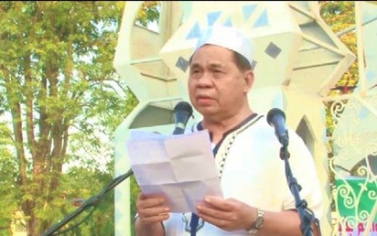 <p><strong>EID’L ADHA MESSAGE.</strong> Bangsamoro Autonomous Region in Muslim Mindanao Chief Minister Ahod “Murad” Ebrahim delivers his Eid'l Adha message during the congregational prayer held inside the BARMM compound in Cotabato City on Sunday. The BARMM minister called for sustained peace and moral governance during the celebration. <em><strong>(Photo courtesy of BPI-BARMM)</strong></em></p>