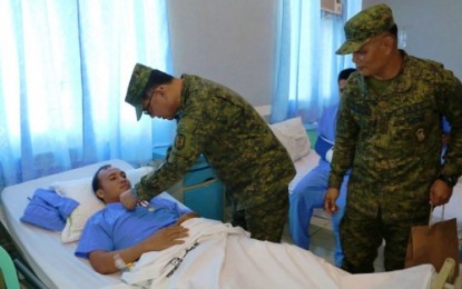 <p><strong>RECOGNIZED BRAVERY.</strong> Major General Diosdado Carreon, Army’s 6th Infantry Division commander, pins the Wounded Personnel Medal to one of the injured soldiers inside the Camp Siongco Station Hospital on Monday, Aug. 12, 2019. <em>(Photo courtesy of 6ID)</em></p>