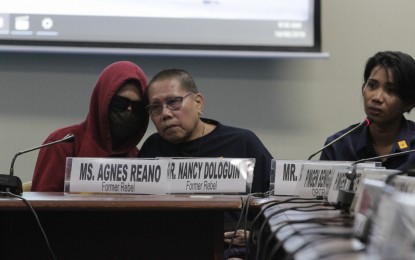 <p><strong>EX-REBELS</strong>. Agnes Reano (middle), who was recruited by a communist group in the early 80s, and "Allem" (wearing a hoodie and shades) testify on Wednesday (Aug. 14) before a Senate hearing on reports of recruitment by the New People's Army in schools. <em>(PNA photo by Avito Dalan)</em></p>